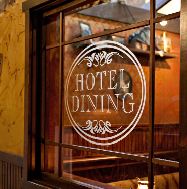 Photo of a window with the words Hotel Dining on it